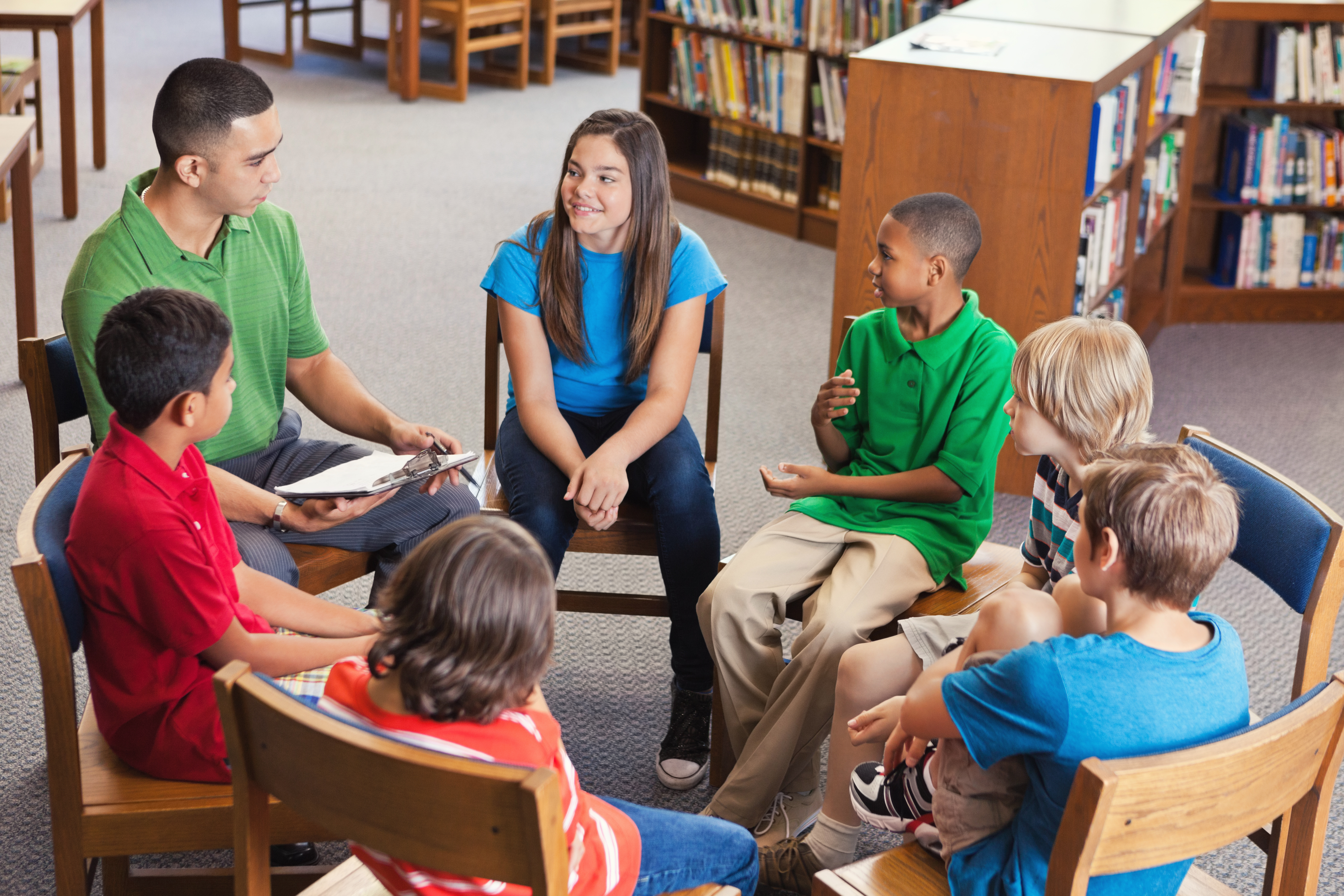 Students sitting in chairs in a circle