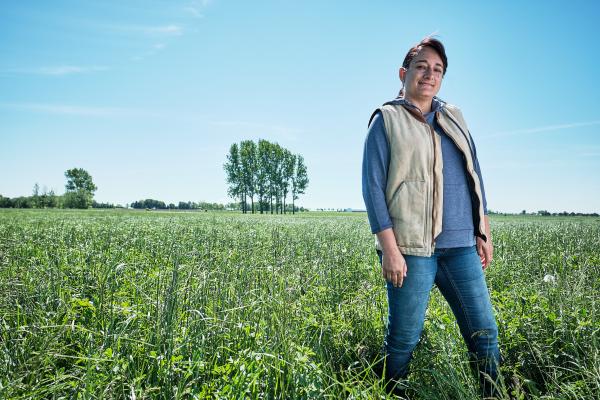 A female Canadian Dairy farmer in a field 